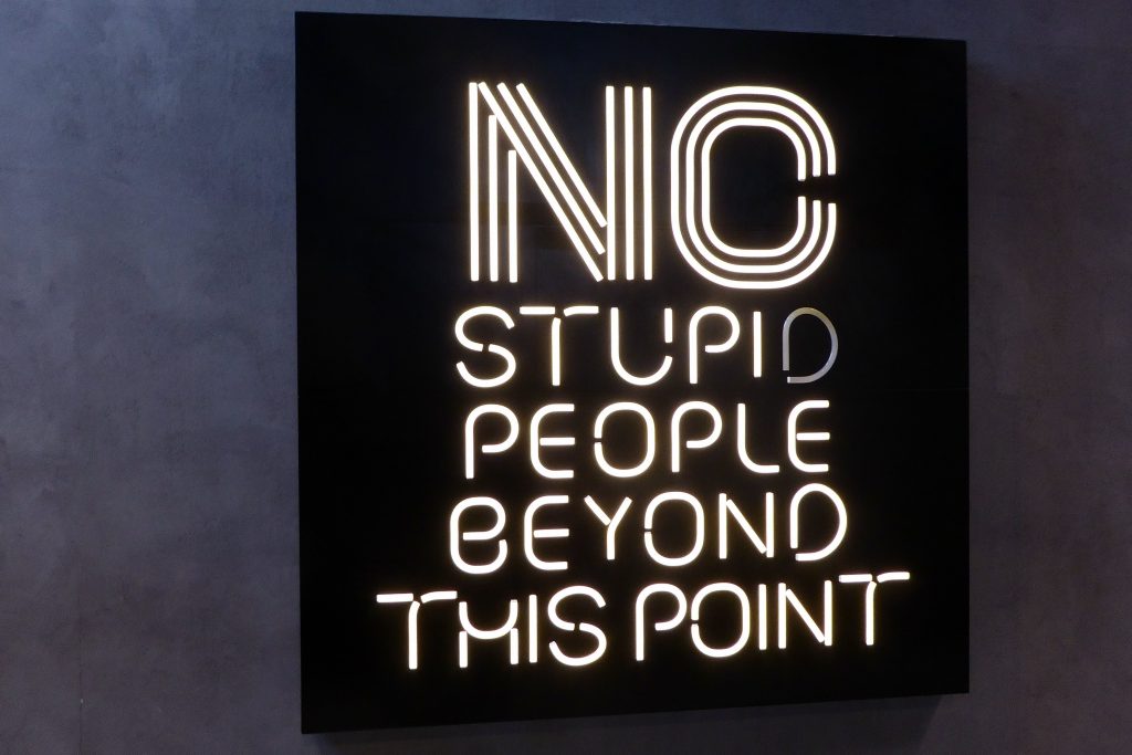 neon sign - no stupid people beyond this point